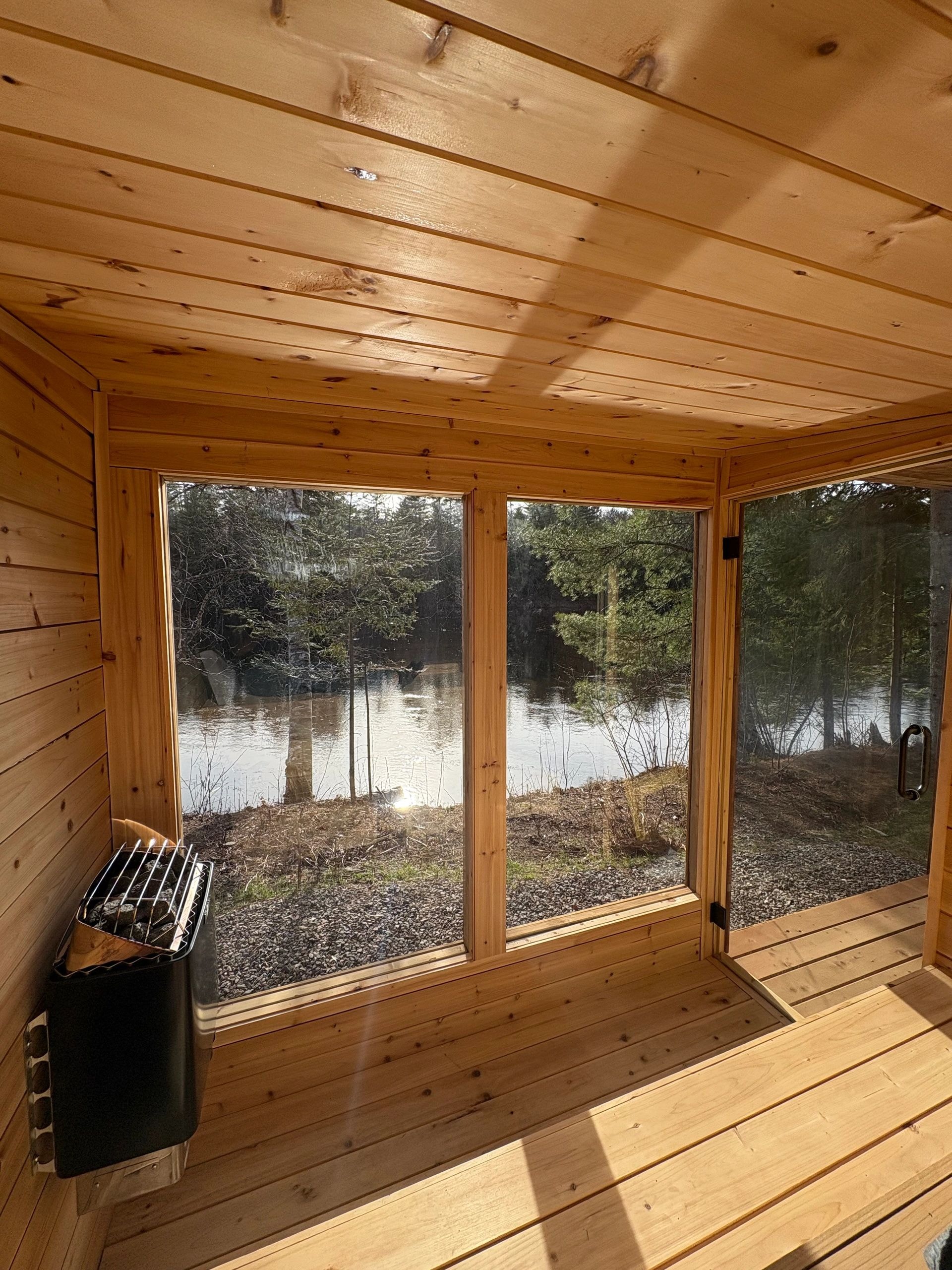 Sunroom with lake views and wood stove